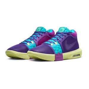 A pair of high-top sneakers in vibrant purple and blue colors with a distinctive Nike swoosh and an Air Max cushioning unit in the sole.