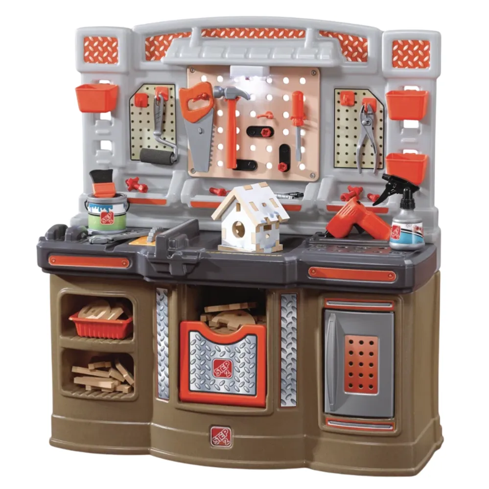 Kids’ workbench toy set with tools and accessories including a hammer, saw, pliers, and a small wooden house model for building.