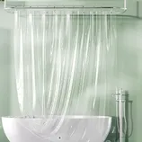 A clear shower curtain with vertical stripes attached to a silver rail above a white bathtub, with a metallic showerhead and faucet on the right.