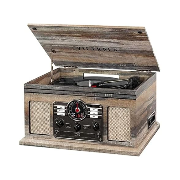 A vintage-style Victrola wooden record player with a hinged lid, equipped with radio and control knobs on the front, complemented by built-in speakers.