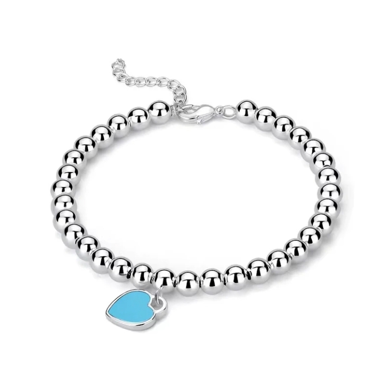 Silver bead bracelet with an attached heart-shaped charm featuring a blue enamel.
