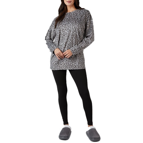 A person is wearing a gray leopard-print sweatshirt, black leggings, and gray slippers.