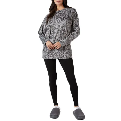 A person is wearing a gray leopard-print sweatshirt, black leggings, and gray slippers.