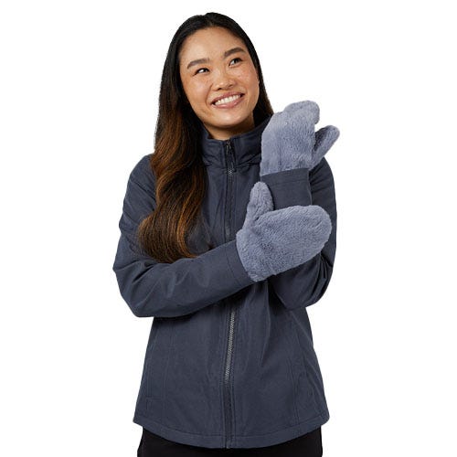 a woman with dark hair in a grey jacket and grey fluffy mittens