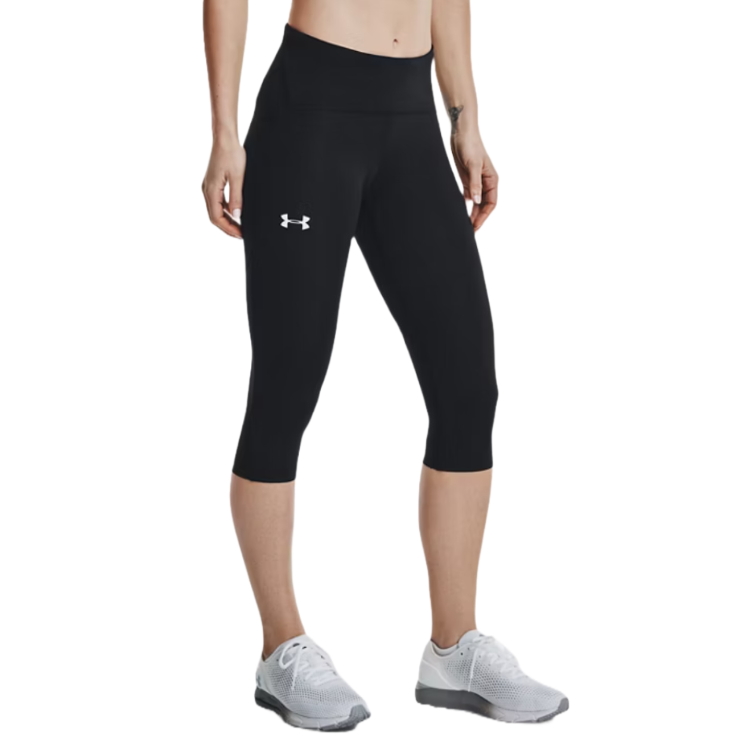UA Fly Fast Capris are black, knee-length athletic leggings with a high waistband and a white Under Armour logo on the leg. They are paired with gray athletic shoes.