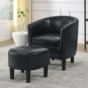 Black leather barrel chair with matching ottoman.