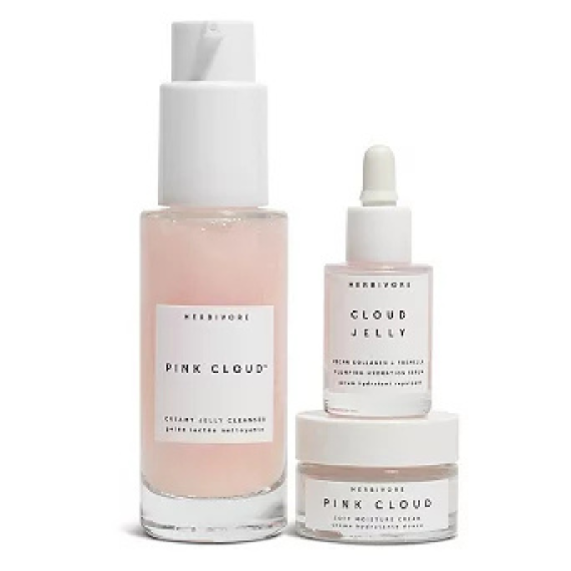 Herbivore Pink Cloud set includes a Creamy Jelly Cleanser, Cloud Jelly Plumping Hydration Serum, and Soft Moisture Cream, all in a light pink hue.