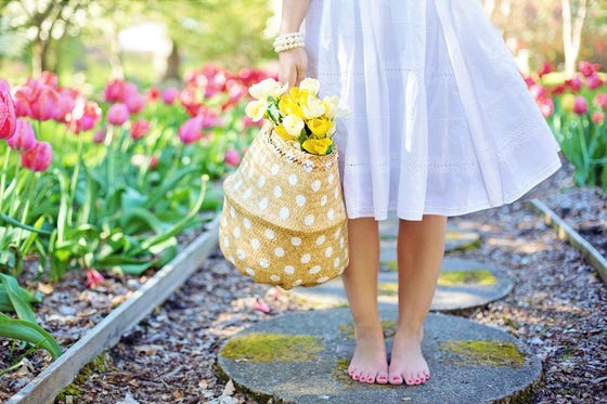 a spring garden with basket full of flowers
