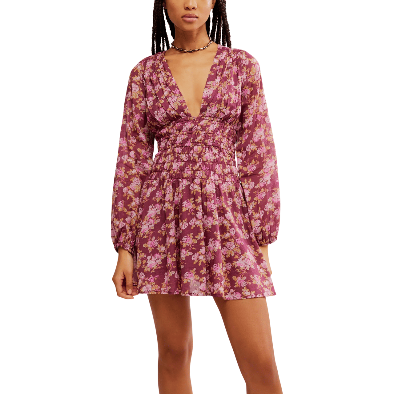A floral long-sleeve mini dress with a deep V-neck and shirred waist, featuring a purple background and pink flower pattern.