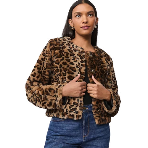 A woman models a leopard print faux fur jacket paired with blue jeans.