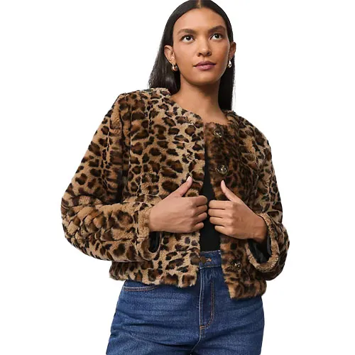 A woman models a leopard print faux fur jacket paired with blue jeans.
