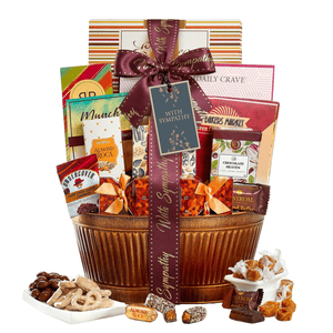 Gift basket with the \“With Sympathy\“ ribbon includes items like Almond Roca, chocolate, caramel, and nuts, presented in a decorative container.