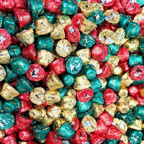 A pile of chocolate candies wrapped in red, green, and gold foil.