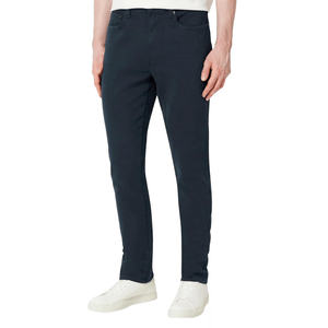 A pair of slim-fit navy chinos paired with white sneakers.