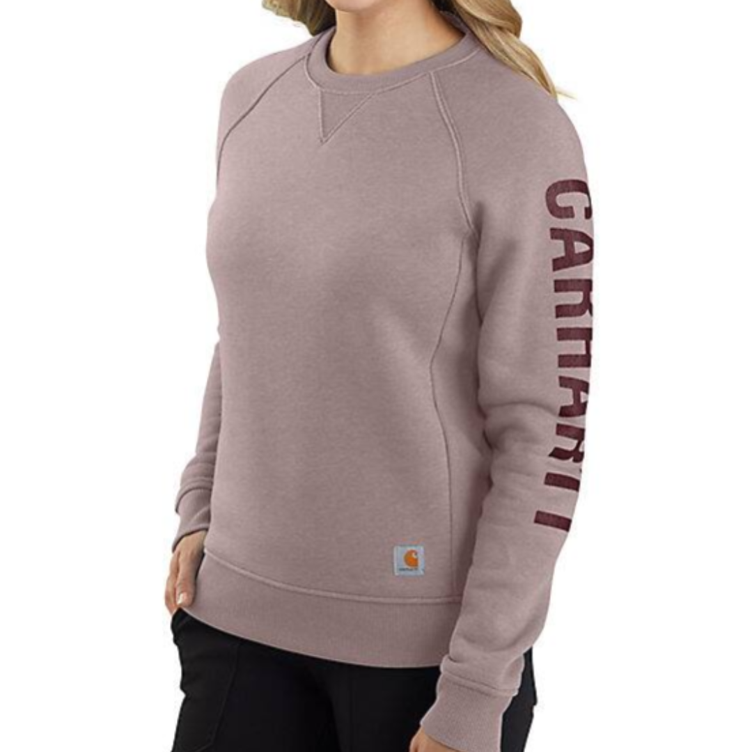 A midweight crewneck sweater in a muted rose color with ribbed cuffs and waistband, featuring the Carhartt logo down the left sleeve and a small logo tag on the hem.