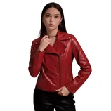 A woman is wearing a red leather motorcycle jacket with asymmetrical zippers and silver hardware, paired with black pants.