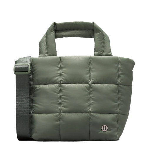 A green, quilted tote bag with padded handles and an adjustable shoulder strap, featuring the Lululemon logo on the front.