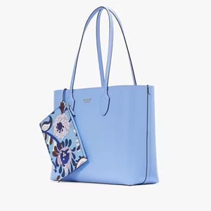A light blue tote bag with matching slim straps and a smaller floral-patterned pouch attached.
