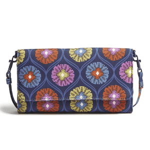 A clutch bag with a detachable strap featuring a colorful, symmetrical floral pattern on a dark blue background.
