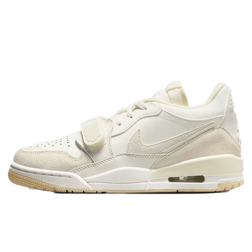 The Nike Air Jordan Legacy 312 Low Shoes feature a cream and beige color scheme with a mix of leather and suede materials, a low-top silhouette, and an air unit in the sole for cushioning. They include a hook-and-loop strap over the laces for added support.