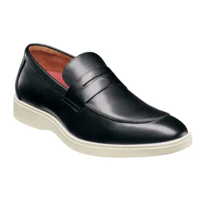 A black leather penny loafer with a white rubber sole and a red interior lining, combining classic and casual elements.