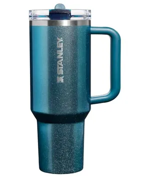 Stanley insulated travel mug in a teal color with a handle and a clear lid, designed to keep beverages hot or cold.