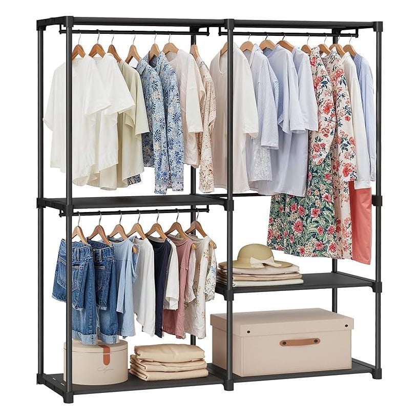 Freestanding wardrobe with two tiers of clothing racks, holding various shirts, dresses, and pants on hangers. Shelves contain folded items, boxes, and hats.