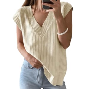 A person is wearing a sleeveless, ribbed knit V-neck sweater in cream color, paired with light blue jeans.