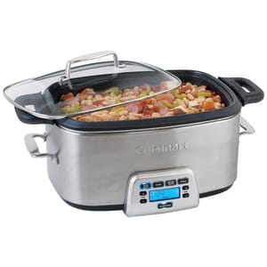A stainless steel slow cooker with a digital control panel displaying a timer. It has a glass lid and is filled with mixed vegetables and beans.