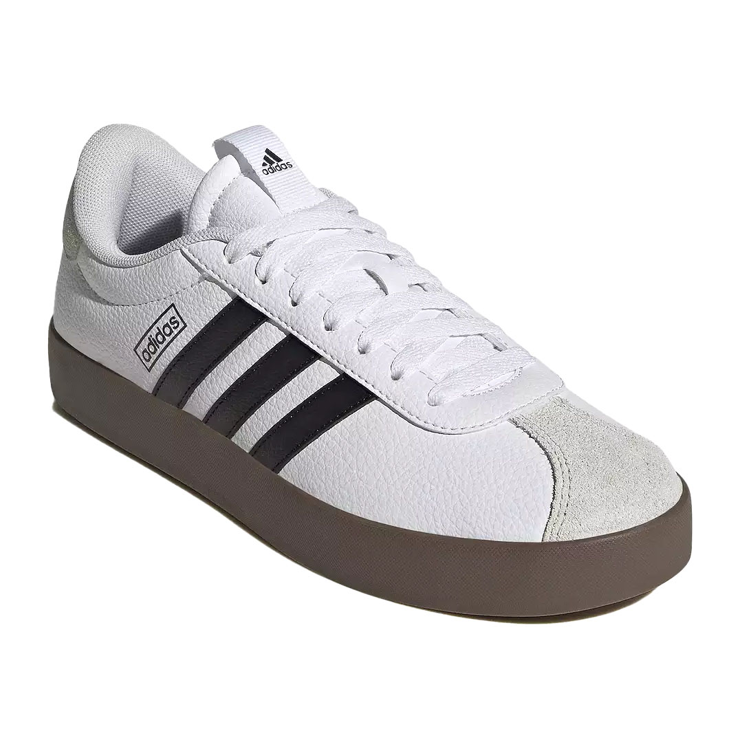 White Adidas sneaker with black stripes, a brown sole, and a suede toe cap.