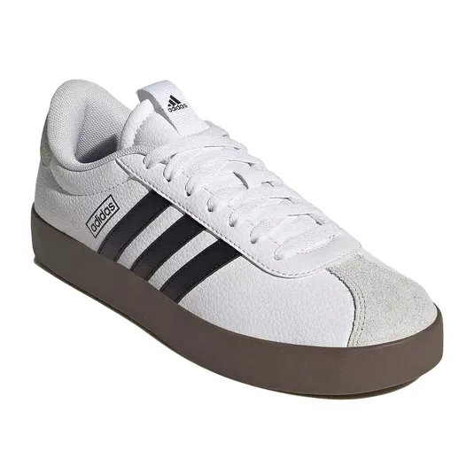 White Adidas sneaker with black stripes, a brown sole, and a suede toe cap.