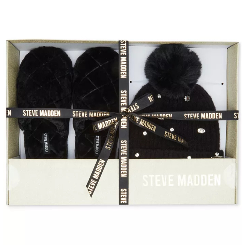 Steve Madden gift box set with a black beanie featuring a pom-pom and decorative embellishments, paired with matching black slippers.