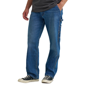 A person is wearing blue denim carpenter jeans with side pockets and black Converse sneakers.