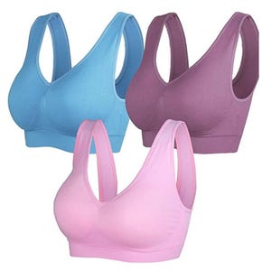 Three seamless sports bras in blue, purple, and pink colors with wide straps and a smooth design for comfort and support.