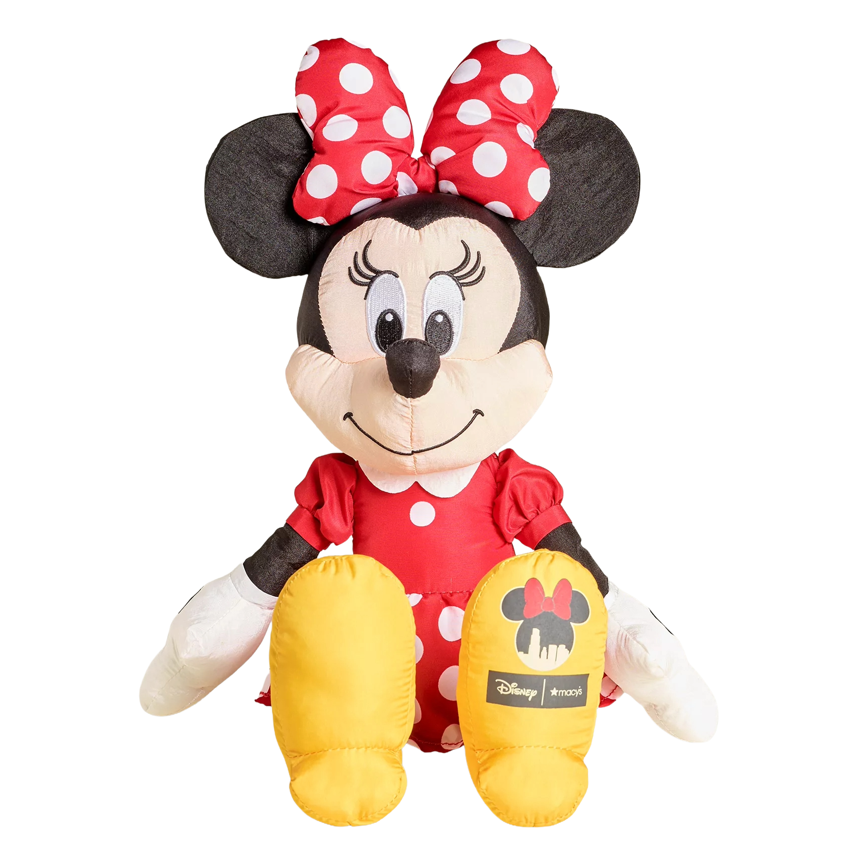 A plush toy of a well-known animated character wearing a red polka-dotted dress and bow, with yellow shoes. The shoes have logos on them.