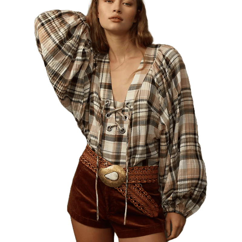 A plaid long-sleeve blouse with puffed shoulders and a lace-up neckline, paired with a woven belt and velvet shorts.