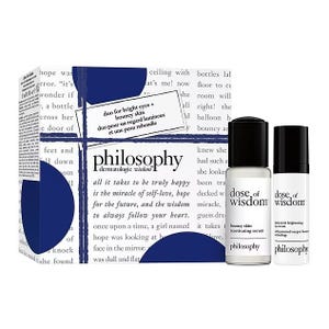Philosophy Eyes & Skin Gift Set includes the \“dose of wisdom\“ bouncy skin reactivating serum and dark circle brightening serum. The packaging emphasizes skin care benefits for bright eyes and bouncy skin.