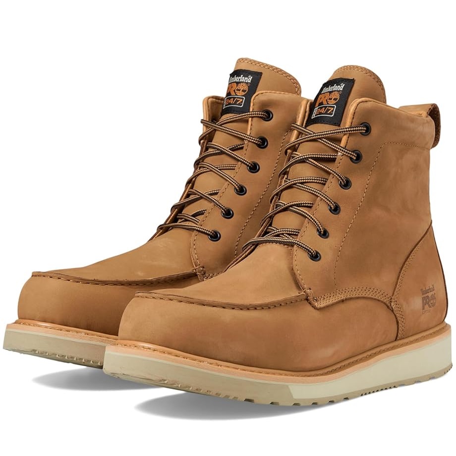 A pair of tan leather lace-up work boots with padded collars and white outsoles.