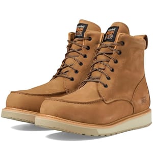 A pair of tan leather lace-up work boots with padded collars and white outsoles.