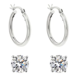 The set includes two pairs of sterling silver earrings: one pair of polished hoop earrings and one pair of round, prong-set cubic zirconia stud earrings.