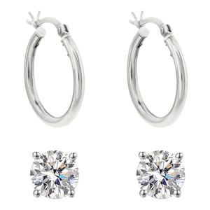 The set includes two pairs of sterling silver earrings: one pair of polished hoop earrings and one pair of round, prong-set cubic zirconia stud earrings.