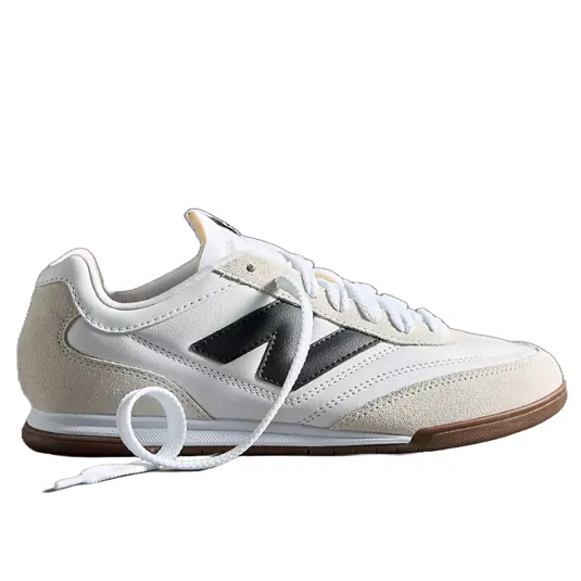 White and beige sneakers with a black \āN\ā logo, featuring a gum sole and white laces.