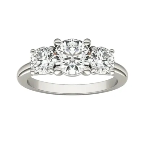 A three-stone diamond ring featuring a larger central round diamond flanked by two smaller round diamonds set in a silver band.