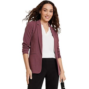Women's open-front blazer in a muted purple color, featuring a tailored fit with a notched lapel collar, long sleeves, and two front pockets. Paired with a white top and black pants, the blazer offers a professional and stylish look.