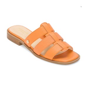 Orange flat sandal with multiple straps, open toe, and a low wooden heel.