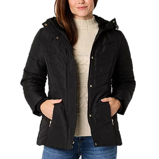 Black quilted hooded jacket with front zipper and button closures, worn over a cream cable-knit sweater and paired with blue jeans.