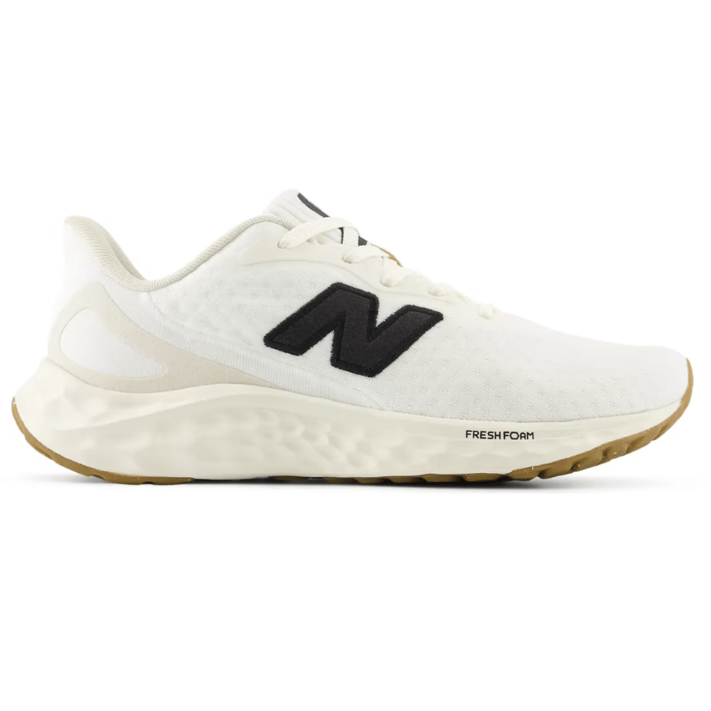White New Balance running shoe featuring a black \“N\“ logo and \“Fresh Foam\“ cushioning, with a gum sole.