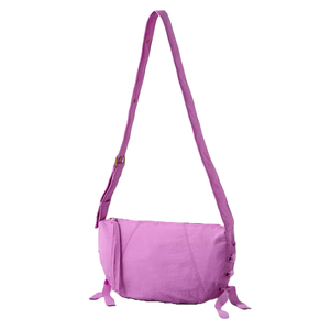 A pink shoulder bag with a long adjustable strap and decorative ties on the sides.