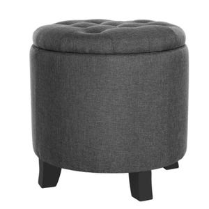 Gray tufted round ottoman with black wooden legs.