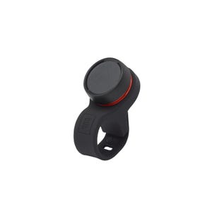 A black bike bell with a sleek design featuring a round button on top and a red accent ring, mounted on a loop that appears to attach to handlebars.